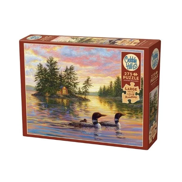 Cobble Hill puzzle box featuring a scenic design of loons on a lake at sunset.