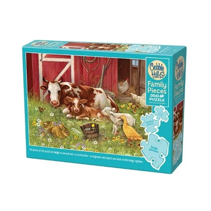 Cobble Hill puzzle box featuring farm animals in the grass in front of a red barn