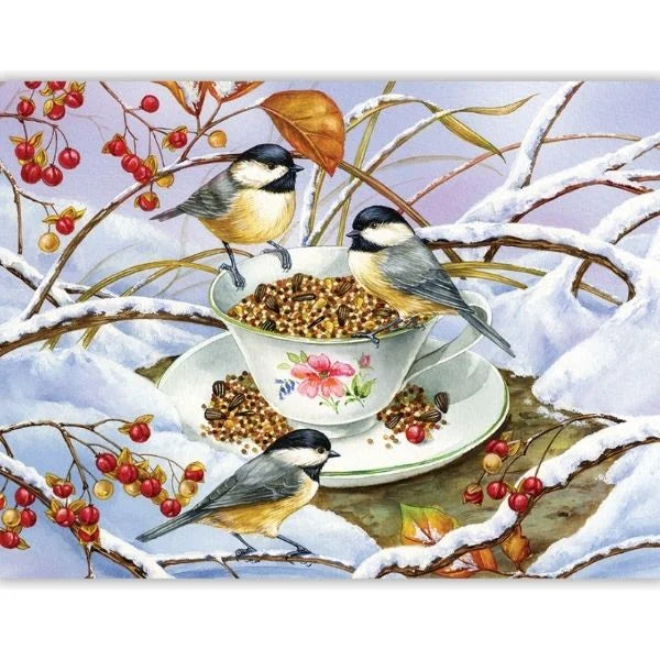 Three birds perched on a teacup filled with birdseed against a snowy background.