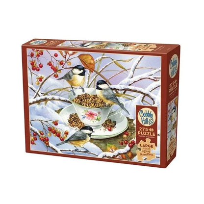 Cobble Hill puzzle box with birds around a teacup and seeds on a snowy branch design.