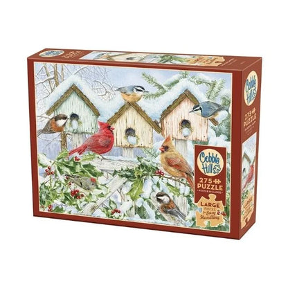 Cobble Hill puzzle box with a winter scene featuring birds and birdhouses.
