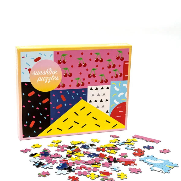 Front view of the 'Wild Cherry' jigsaw puzzle box and puzzle piecesby Sunshine Puzzles